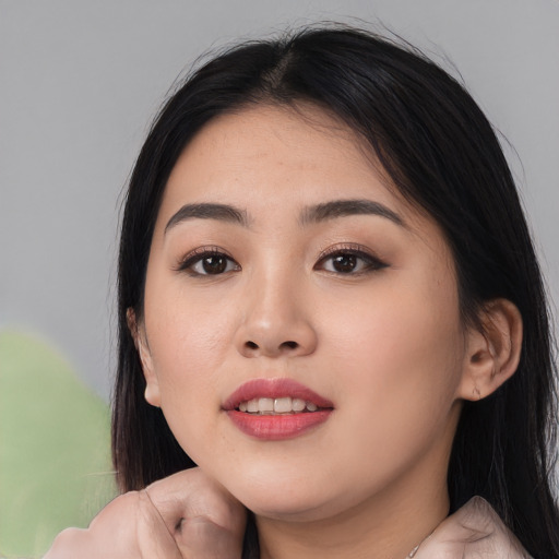 Joyful asian young-adult female with medium  black hair and brown eyes