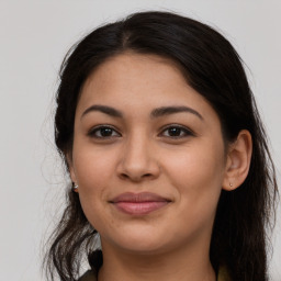 Joyful latino young-adult female with long  brown hair and brown eyes