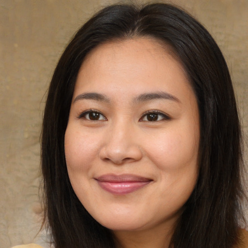 Joyful asian young-adult female with long  brown hair and brown eyes