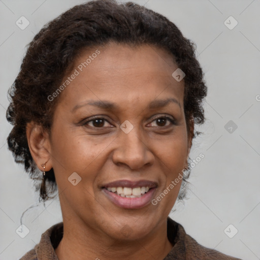 Joyful black adult female with medium  brown hair and brown eyes