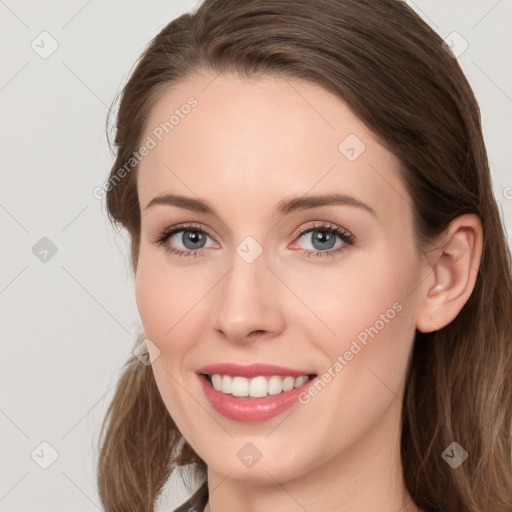 Joyful white young-adult female with long  brown hair and grey eyes