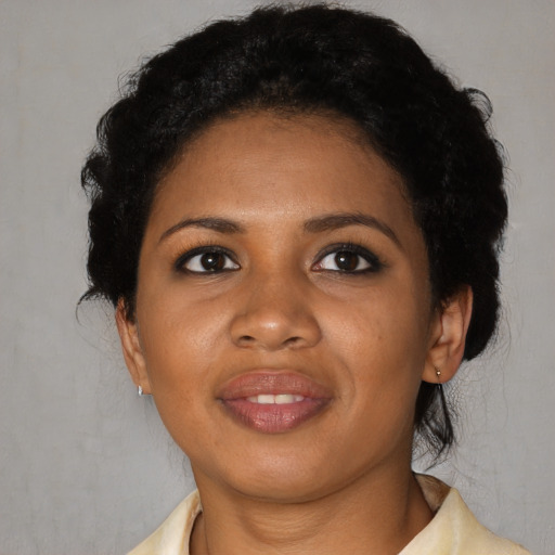 Joyful black adult female with medium  black hair and brown eyes