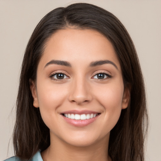 Joyful white young-adult female with long  brown hair and brown eyes