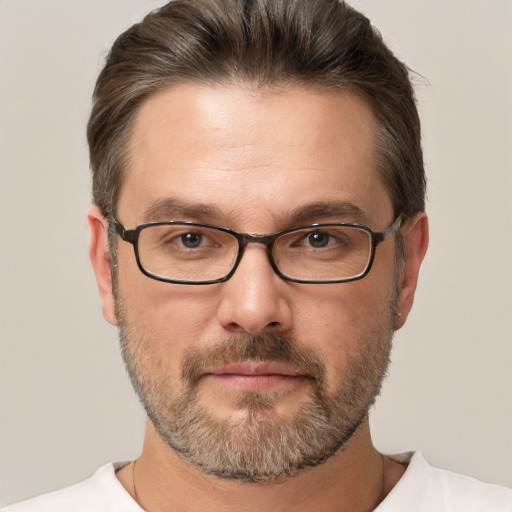 Joyful white adult male with short  brown hair and brown eyes