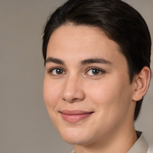 Joyful white young-adult female with short  brown hair and brown eyes