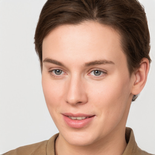 Joyful white young-adult female with short  brown hair and grey eyes