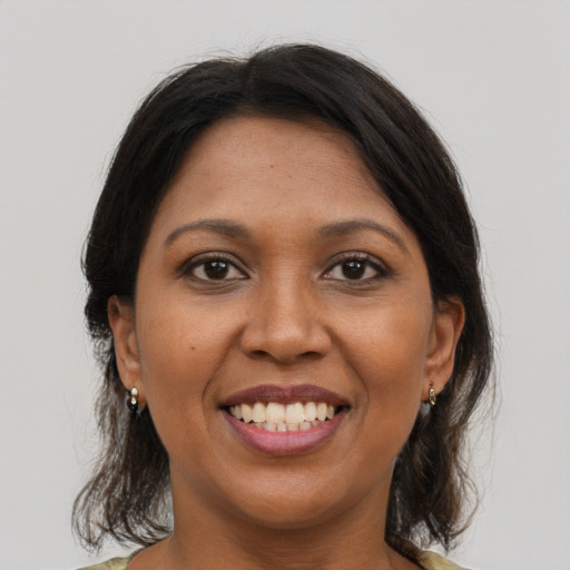 Joyful black young-adult female with medium  brown hair and brown eyes