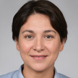 Joyful white adult female with short  brown hair and brown eyes