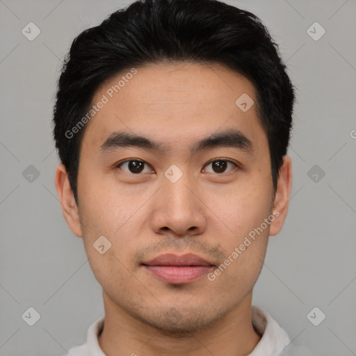 Joyful asian young-adult male with short  black hair and brown eyes