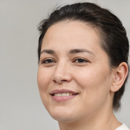 Joyful white adult female with medium  brown hair and brown eyes