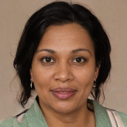 Joyful black adult female with medium  brown hair and brown eyes