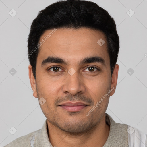 Joyful latino young-adult male with short  black hair and brown eyes