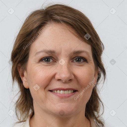 Joyful white adult female with medium  brown hair and brown eyes