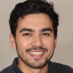 Joyful white young-adult male with short  black hair and brown eyes