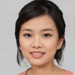 Joyful asian young-adult female with medium  black hair and brown eyes