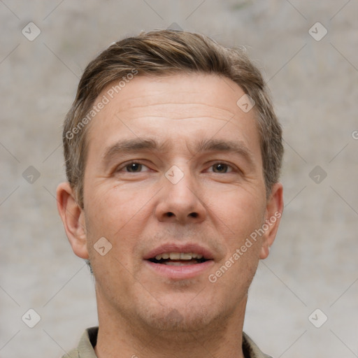 Joyful white adult male with short  brown hair and brown eyes