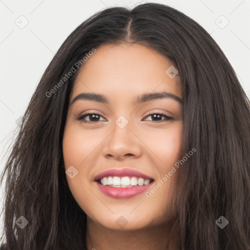 Joyful latino young-adult female with long  black hair and brown eyes