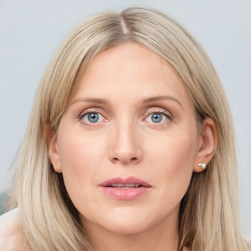 Joyful white young-adult female with long  brown hair and blue eyes