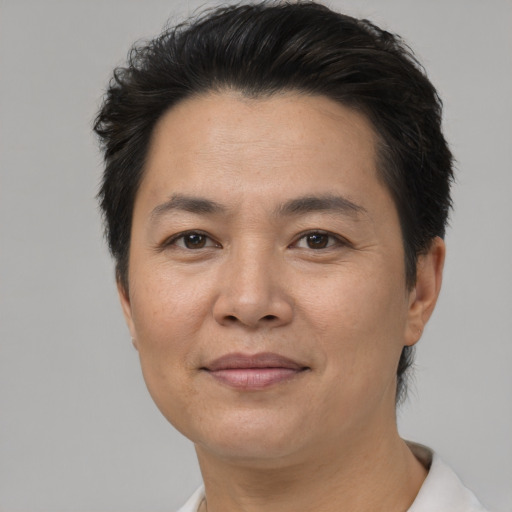 Joyful asian adult female with short  brown hair and brown eyes