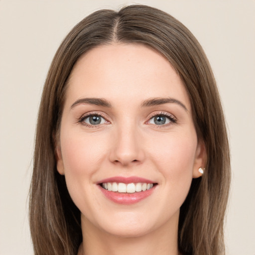 Joyful white young-adult female with long  brown hair and green eyes