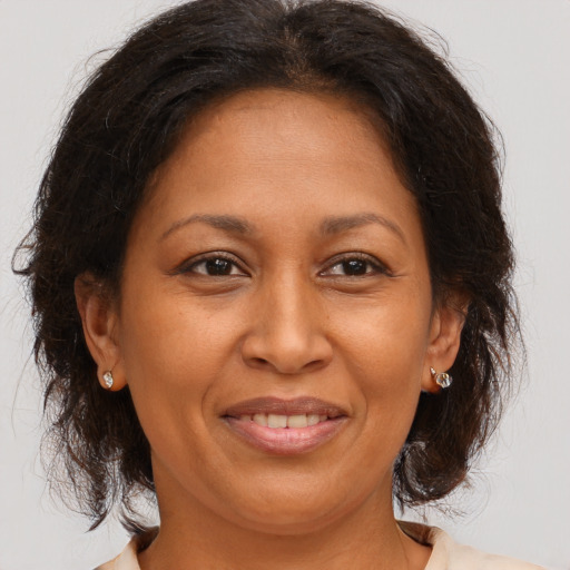 Joyful white adult female with medium  brown hair and brown eyes