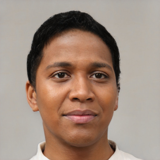 Joyful black young-adult female with short  black hair and brown eyes