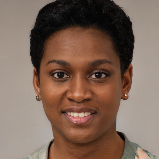Joyful black young-adult female with short  black hair and brown eyes