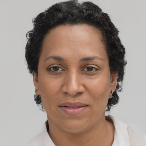 Joyful latino adult female with short  brown hair and brown eyes