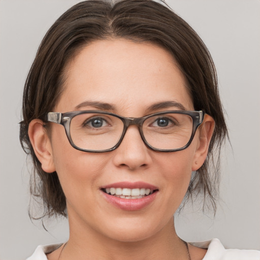 Joyful white adult female with medium  brown hair and brown eyes