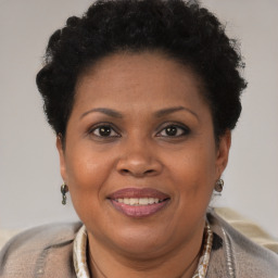 Joyful black adult female with short  brown hair and brown eyes