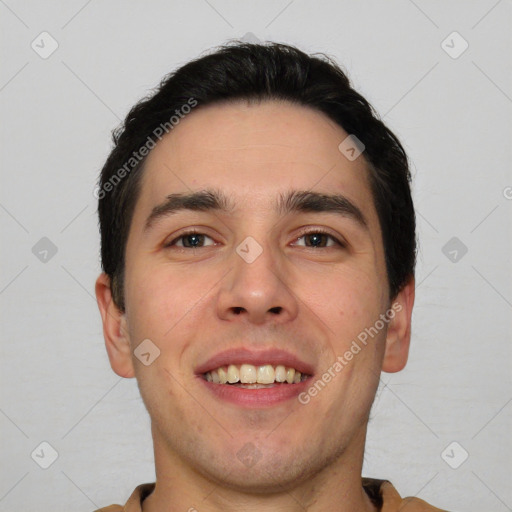 Joyful white young-adult male with short  black hair and brown eyes