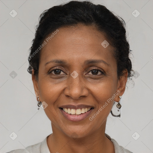 Joyful latino adult female with short  brown hair and brown eyes