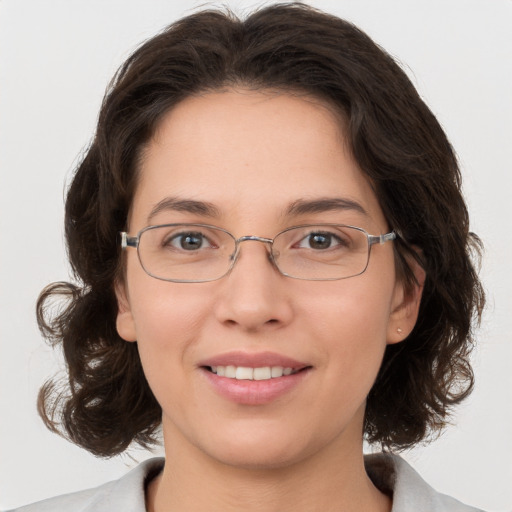 Joyful white adult female with medium  brown hair and brown eyes