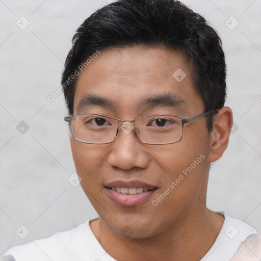 Joyful asian young-adult male with short  black hair and brown eyes