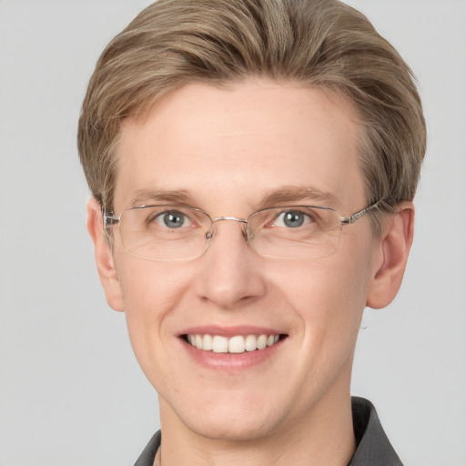 Joyful white adult male with short  brown hair and blue eyes