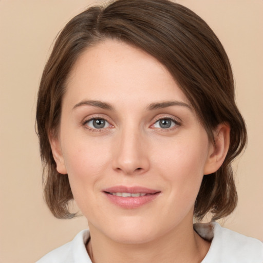 Joyful white young-adult female with medium  brown hair and green eyes