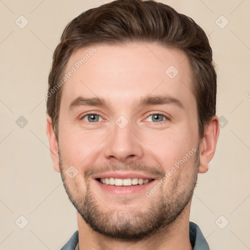 Joyful white young-adult male with short  brown hair and grey eyes