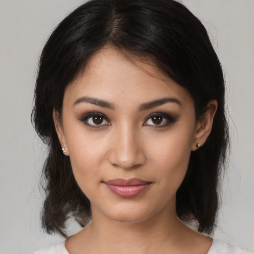Joyful latino young-adult female with medium  brown hair and brown eyes