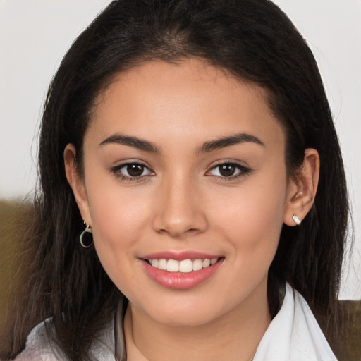 Joyful white young-adult female with long  brown hair and brown eyes