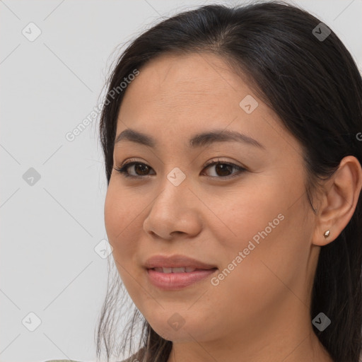 Joyful asian young-adult female with long  brown hair and brown eyes