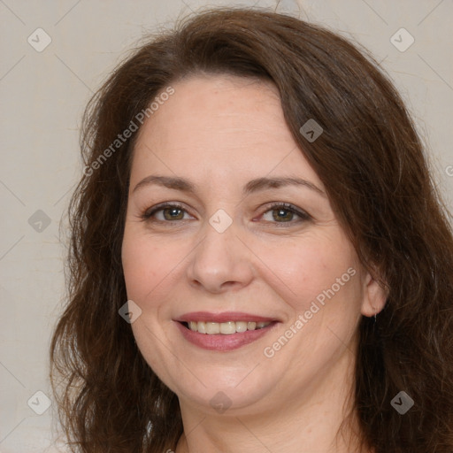 Joyful white adult female with long  brown hair and brown eyes