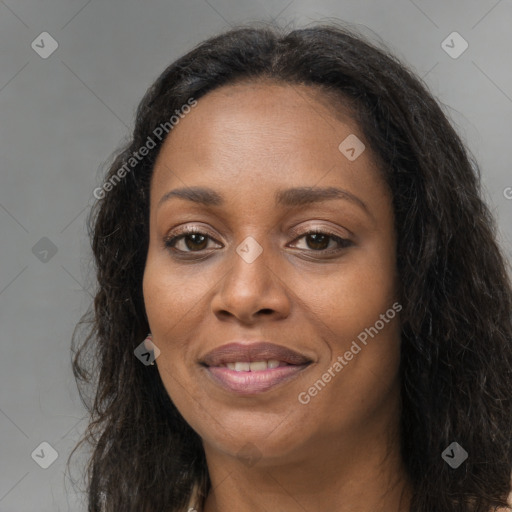 Joyful black adult female with long  brown hair and brown eyes