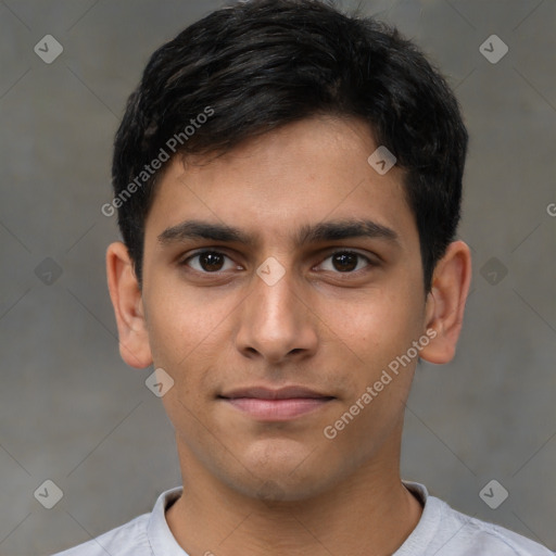 Joyful latino young-adult male with short  brown hair and brown eyes