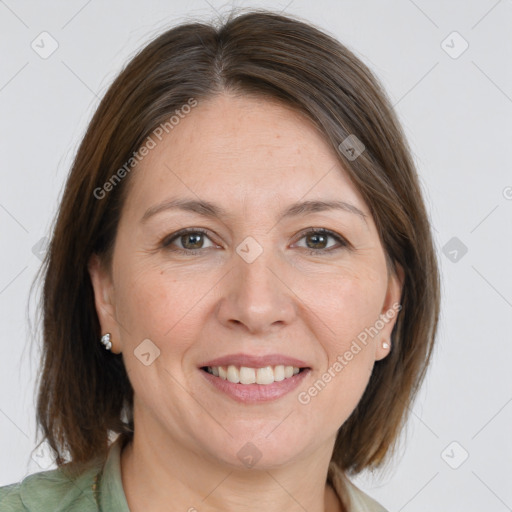 Joyful white adult female with medium  brown hair and brown eyes