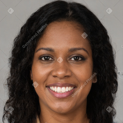 Joyful black young-adult female with long  brown hair and brown eyes