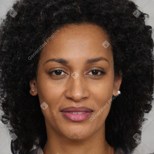 Joyful black adult female with long  brown hair and brown eyes