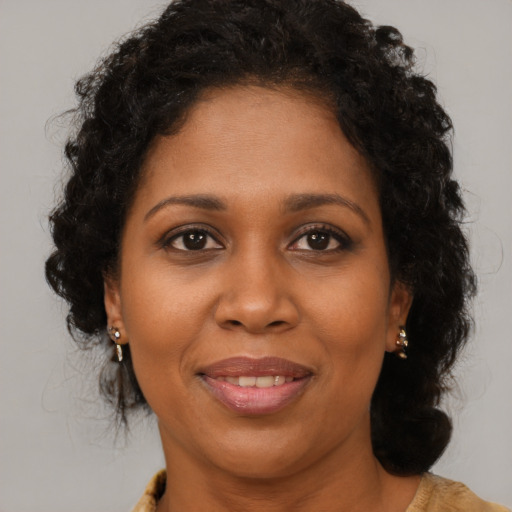 Joyful black young-adult female with medium  brown hair and brown eyes