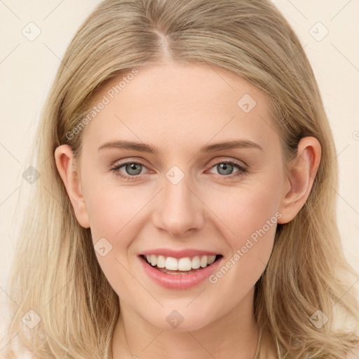 Joyful white young-adult female with long  brown hair and blue eyes