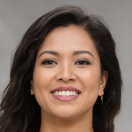 Joyful asian young-adult female with long  brown hair and brown eyes