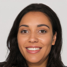 Joyful latino young-adult female with long  brown hair and brown eyes